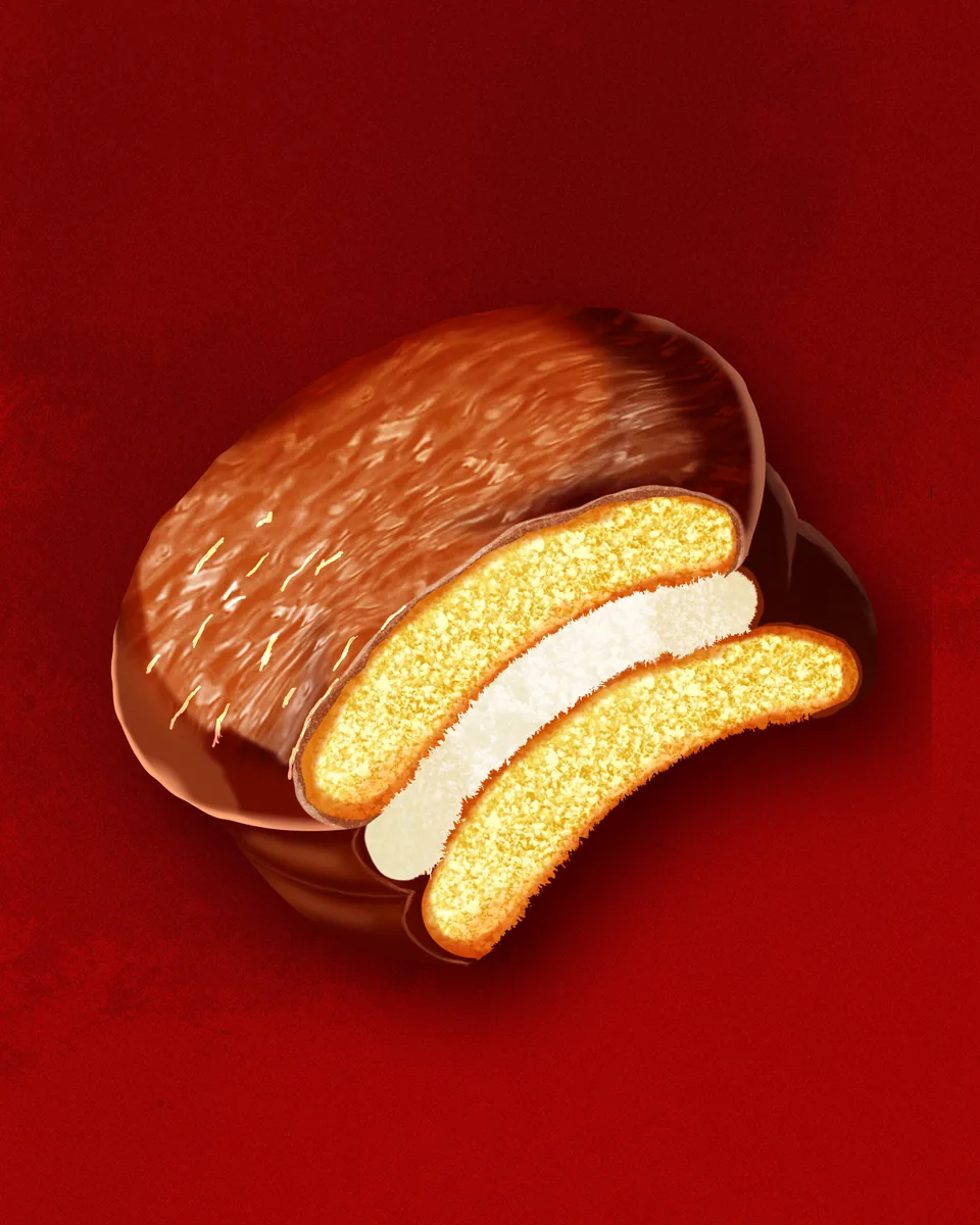 A glossy chocolate pie cut open to show sponge and marshmallow layers, on a deep red background.